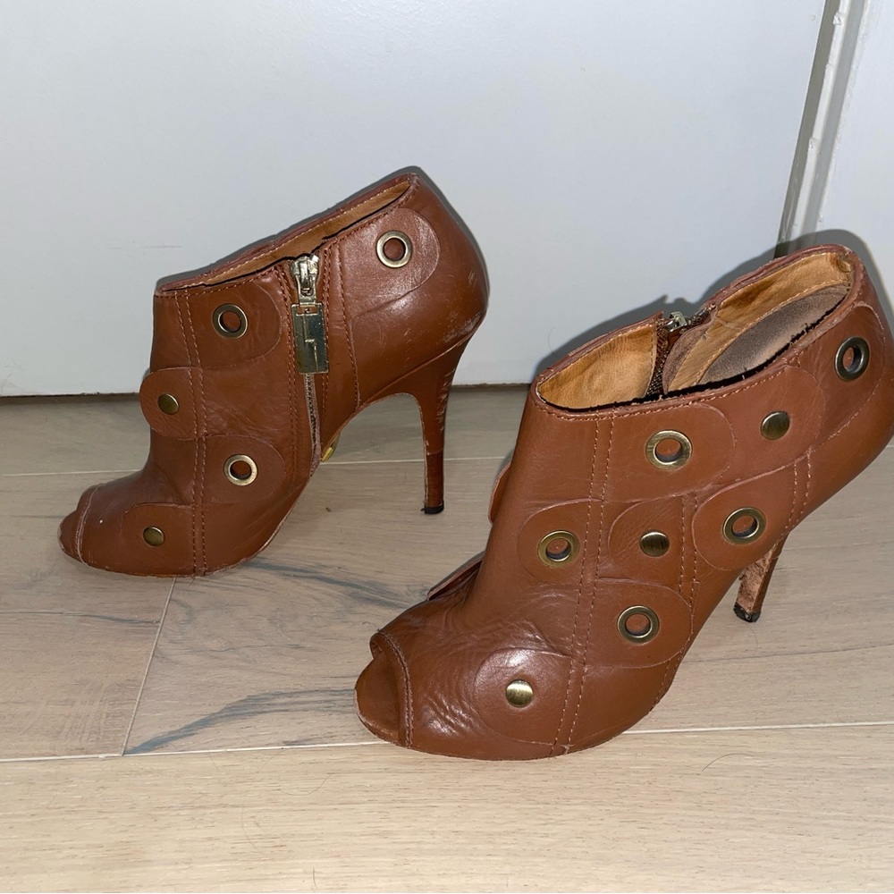 L.A.M.B. Pumps in camel brown with brass accents.